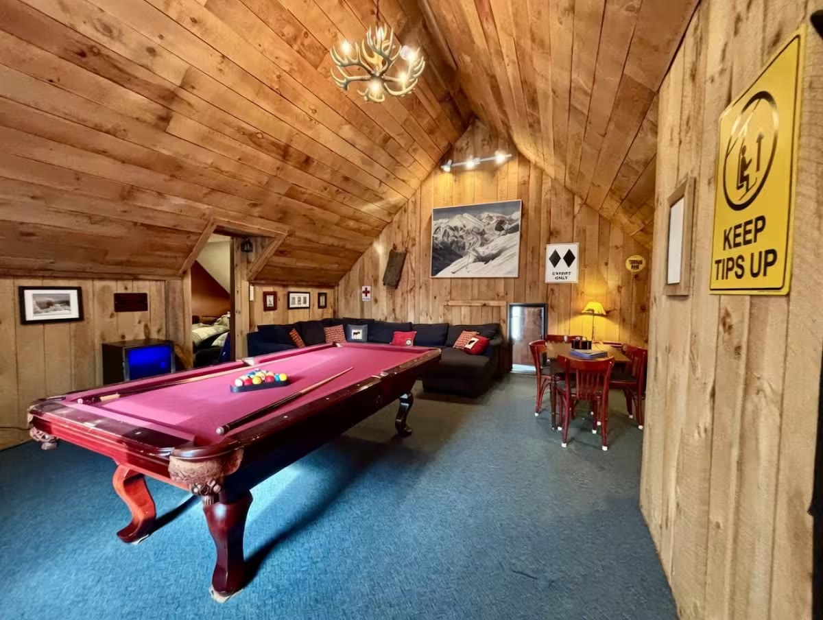 Game room with pool table and vaulted wood ceiling